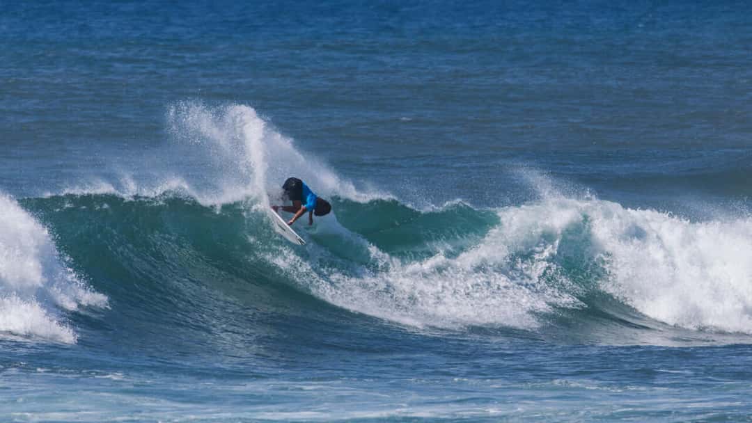 Shayden Pacarro, con lycra azul, gira de revés en una ola de Sunset Beach durante el HTA Sunset Pro 2026