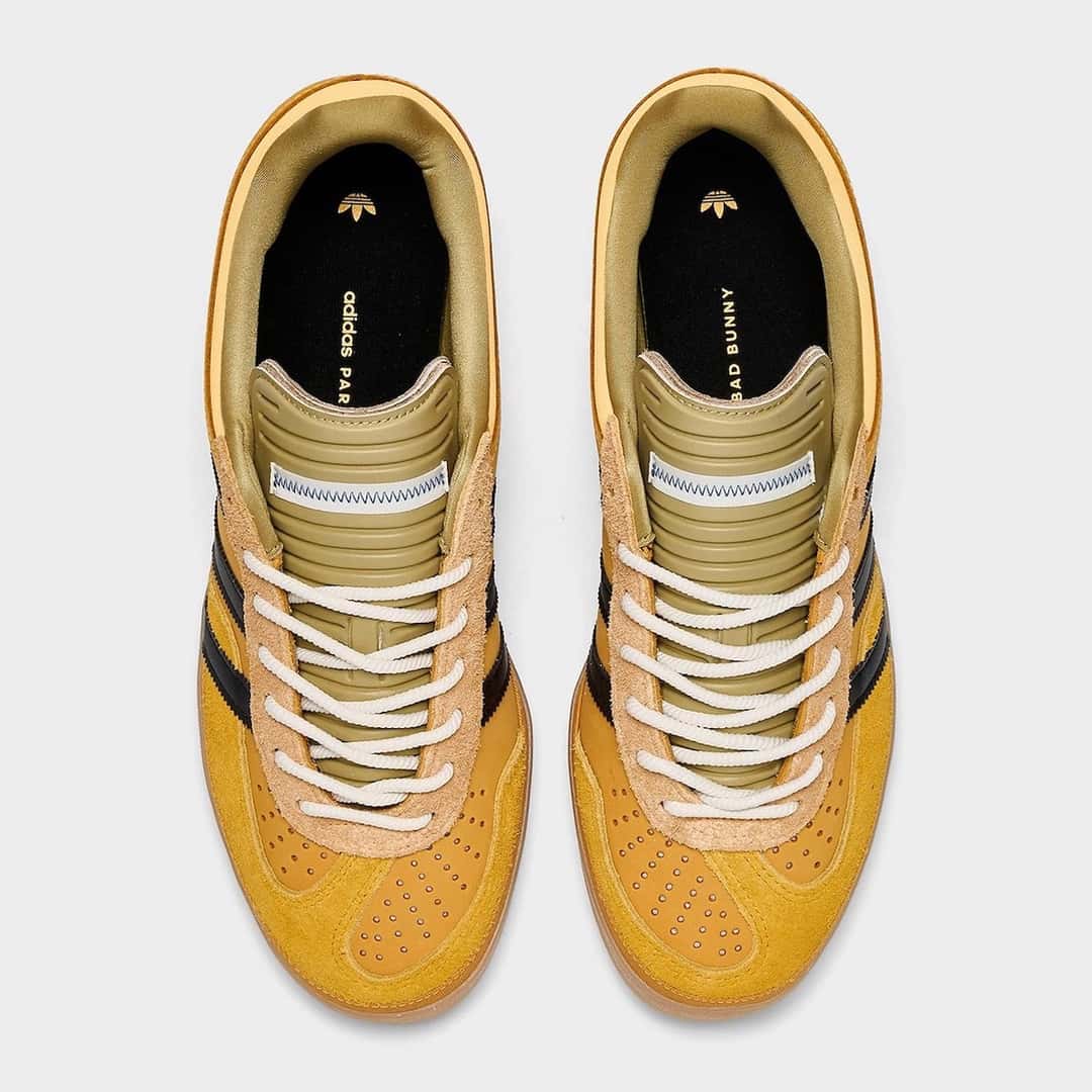 Vista superior de la Bad Bunny x adidas Gazelle Indoor Solar Gold con lengüeta acolchada verde oliva, cordones de cuerda crema y plantilla con firma Bad Bunny