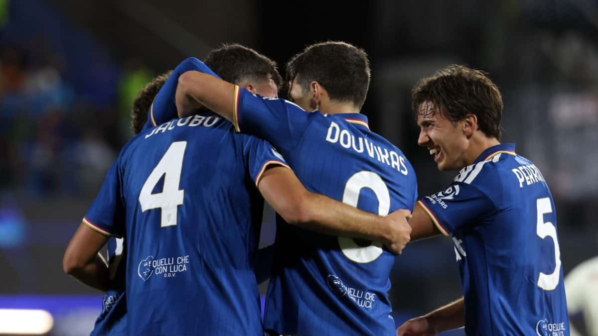 Jugadores del Como, con la camiseta azul, se abrazan para festejar un gol al Manchester United en el estadio Giuseppe Sinigaglia; entre ellos, Douvikas y Perrone, de espaldas (foto: prensa Como 1907)