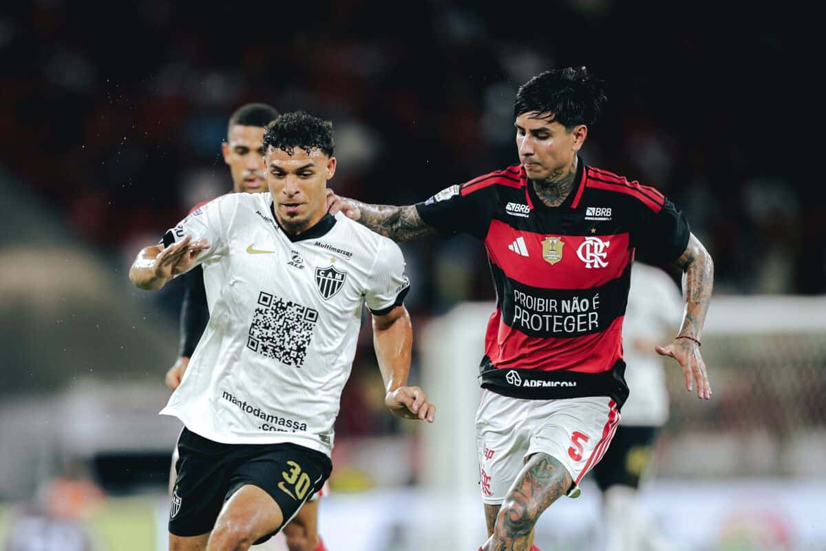 Un jugador del Atlético Mineiro, con la camiseta blanca, conduce la pelota perseguido por un futbolista del Flamengo, con la camiseta rojinegra, en el Maracaná (foto: Pedro Souza / prensa oficial de Atlético Mineiro)